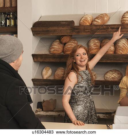 Woman pointing at bread on shelf View Large Photo Image Stock Image - Woman pointing at bread on shelf. Fotosearch