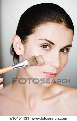 Woman putting face mask on View Large Photo Image Stock Image - Woman putting face mask on. Fotosearch