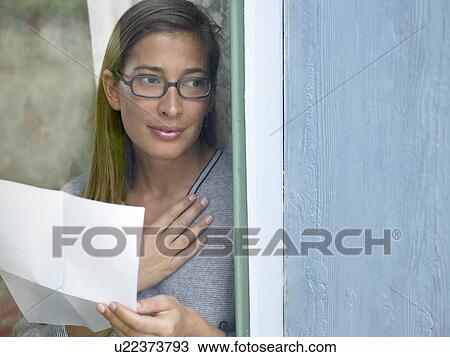 Stock Image - Woman reading a letter. Fotosearch