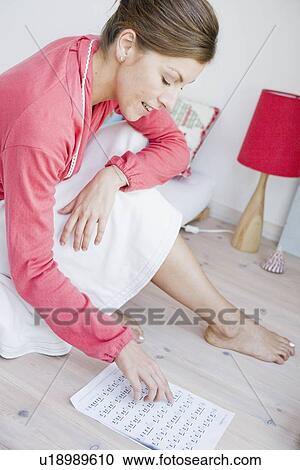 Stock Image - Woman reading music sheet. Fotosearch
