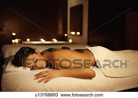 Woman receiving hot stone massage View Large Photo Image Stock Image - Woman receiving hot stone massage. Fotosearch