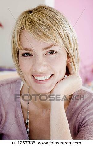 Stock Photograph - Woman smiling at viewer. Fotosearch