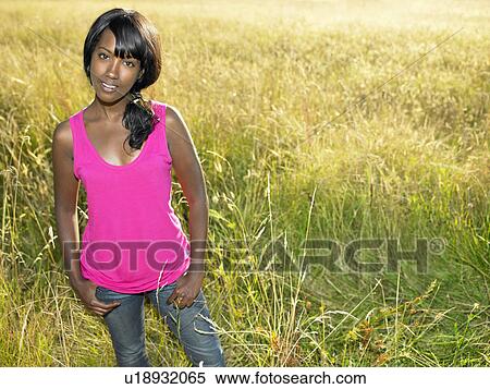 "Woman standing in a field, smiling" View Large Photo Image Stock Photography - "Woman standing in a field, smiling". Fotosearch