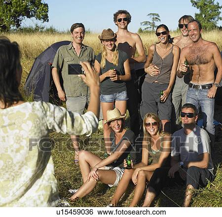 Woman taking a picture of her friends View Large Photo Image Stock Photograph - Woman taking a picture of her friends. Fotosearch