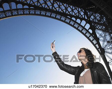 Woman taking picture of Eiffel tower View Large Photo Image Stock Image - Woman taking picture of Eiffel tower. Fotosearch