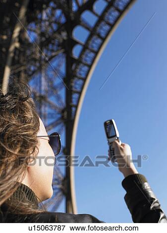 Woman taking picture of Eiffel tower View Large Photo Image Stock Photo - Woman taking picture of Eiffel tower. Fotosearch