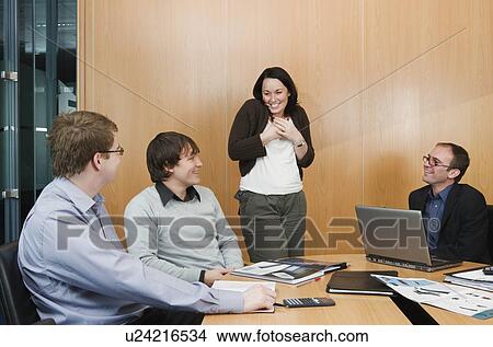 Picture - Woman talking in office meeting. Fotosearch