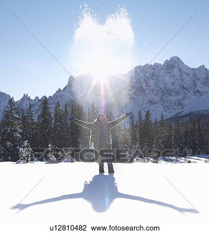 Woman throwing snow up into the air View Large Photo Image Stock Image - Woman throwing snow up into the air. Fotosearch