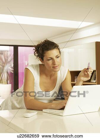 Woman using credit card with laptop View Large Photo Image Stock Photo - Woman using credit card with laptop. Fotosearch
