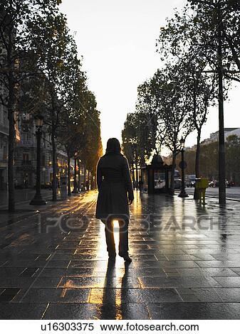 Stock Photography - Woman walking on Champs Elysees. Fotosearch