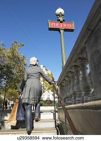 Woman walking out of Paris underground View Large Photo Image Picture - Woman walking out of Paris underground. Fotosearch