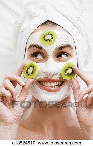 Woman with face mask and kiwi fruit View Large Photo Image Stock Image - Woman with face mask and kiwi fruit. Fotosearch