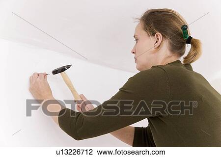 Woman with hammer and nail View Large Photo Image Stock Image - Woman with hammer and nail. Fotosearch