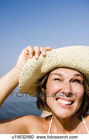 Stock Image - Woman with hat smiling. Fotosearch