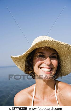 Woman with hat smiling View Large Photo Image Stock Photo - Woman with hat smiling. Fotosearch