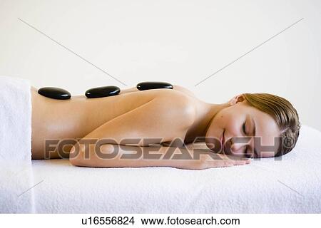 Picture - Woman with hot stones. Fotosearch