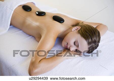 Stock Photo - Woman with hot stones. Fotosearch