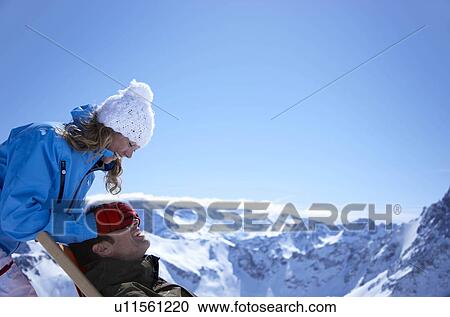 Stock Image - Woman with man sitting in deck chair. Fotosearch