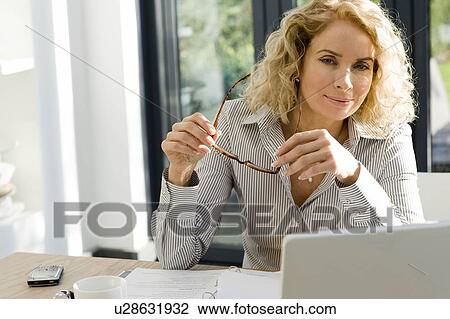 Woman working at office or home View Large Photo Image Stock Image - Woman working at office or home. Fotosearch