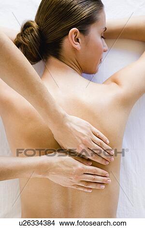 Picture - Woman's back being massaged. Fotosearch