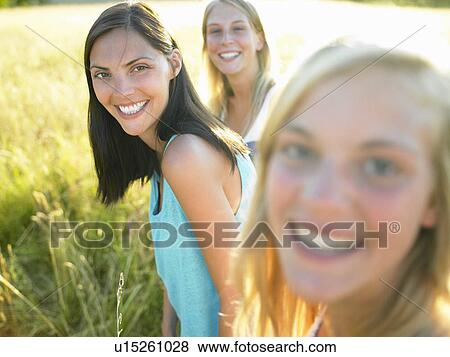 "Women in a field, smiling" View Large Photo Image Stock Photo - "Women in a field, smiling". Fotosearch