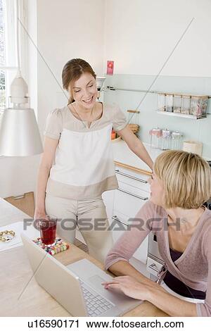 Women in kitchen talking View Large Photo Image Stock Image - Women in kitchen talking. Fotosearch