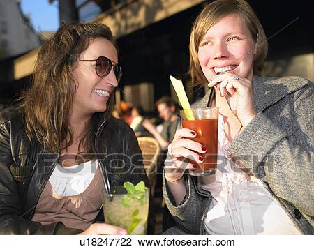 Stock Image - Women on terrace of café. Fotosearch