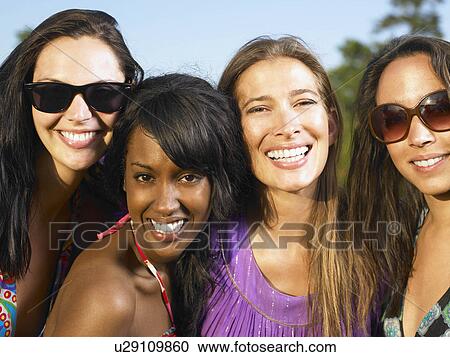 Stock Image - Women smiling at camera. Fotosearch
