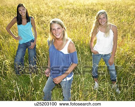 "Women standing in a field, smiling" View Large Photo Image Stock Image - "Women standing in a field, smiling". Fotosearch