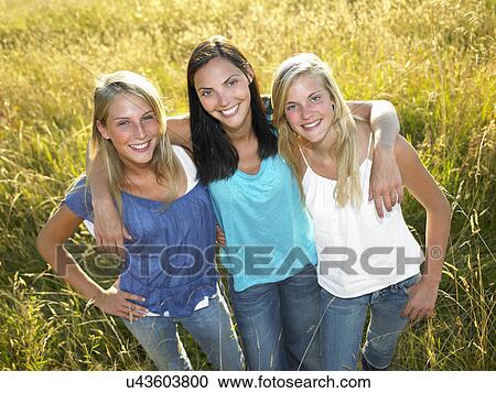 "Women standing in a field, smiling" View Large Photo Image Stock Image - "Women standing in a field, smiling". Fotosearch