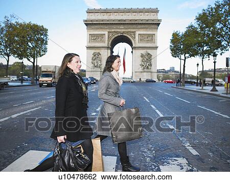 Stock Image - Women walking on Champs Elysees. Fotosearch