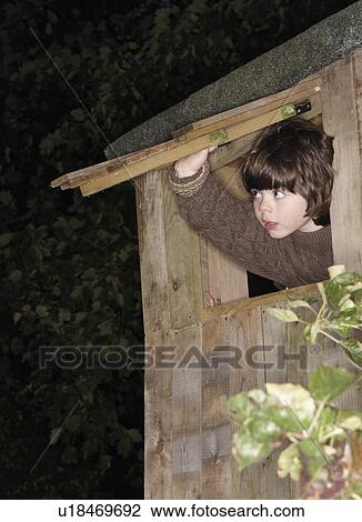 Young boy at treehouse window View Large Photo Image Stock Image - Young boy at treehouse window. Fotosearch