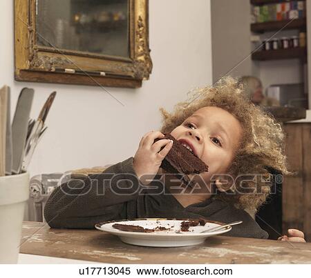 Young boy eating chocolate cake View Large Photo Image Stock Photography - Young boy eating chocolate cake. Fotosearch