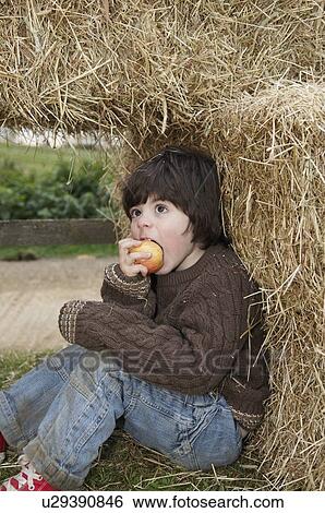 Young boy in hay bales View Large Photo Image Stock Photograph - Young boy in hay bales. Fotosearch