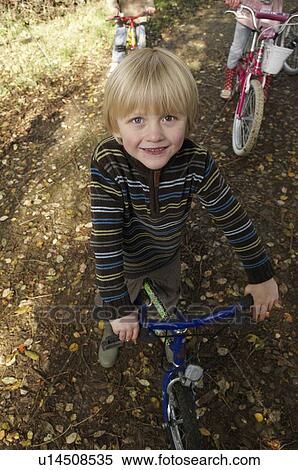 Stock Photography - Young boy on bike on country lane. Fotosearch