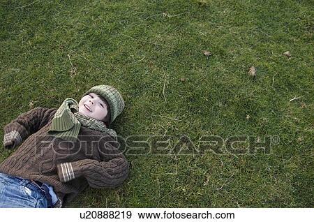 Stock Photo - Young boy on grass. Fotosearch