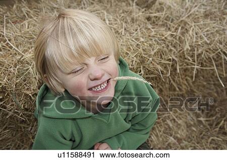 Young boy on hay bales View Large Photo Image Stock Image - Young boy on hay bales. Fotosearch