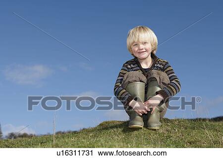 Young boy on hill in countryside View Large Photo Image Stock Image - Young boy on hill in countryside. Fotosearch