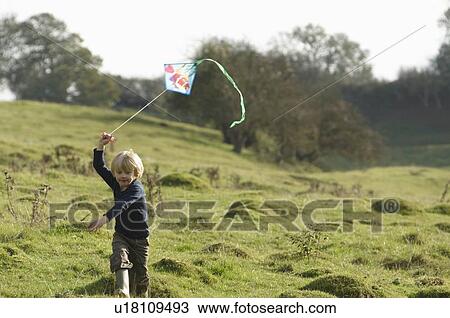 Young boy running with kite View Large Photo Image Stock Image - Young boy running with kite. Fotosearch