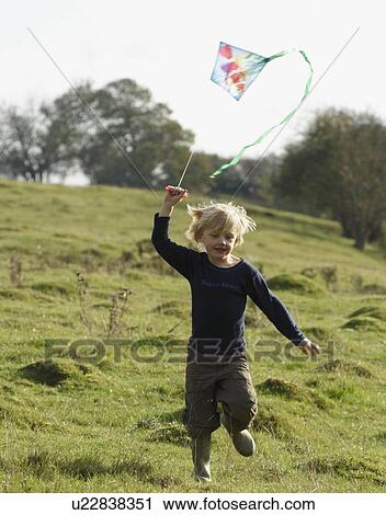 Young boy running with kite View Large Photo Image Stock Image - Young boy running with kite. Fotosearch