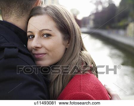 Stock Image - Young couple embracing. Fotosearch