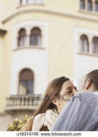 Young couple kissing in street View Large Photo Image Stock Photo - Young couple kissing in street. Fotosearch