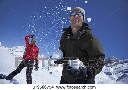 Picture - Young couple playing in snow. Fotosearch