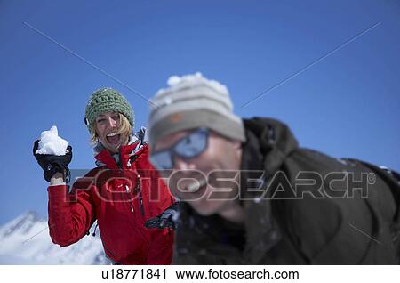 Young couple playing in snow View Large Photo Image Stock Image - Young couple playing in snow. Fotosearch