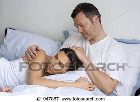 Stock Photo - Young couple relaxing at home. Fotosearch