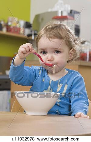 Young girl eating and spilling pudding View Large Photo Image Stock Photo - Young girl eating and spilling pudding. Fotosearch
