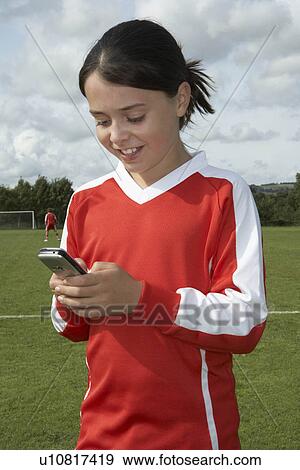 Stock Photo - Young girl on mobile phone. Fotosearch