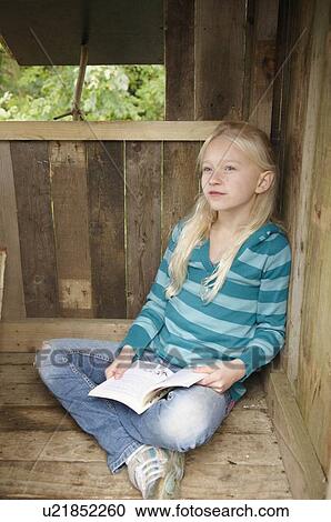Young girl reading in treehouse View Large Photo Image Stock Image - Young girl reading in treehouse. Fotosearch