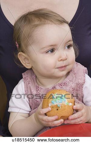 Stock Image - "Young girl with cake, close up". Fotosearch
