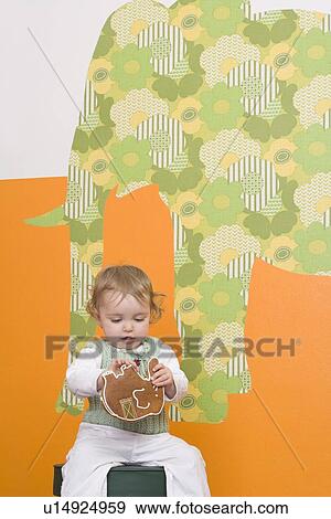 Young girl with gingerbread elephant View Large Photo Image Stock Photo - Young girl with gingerbread elephant. Fotosearch